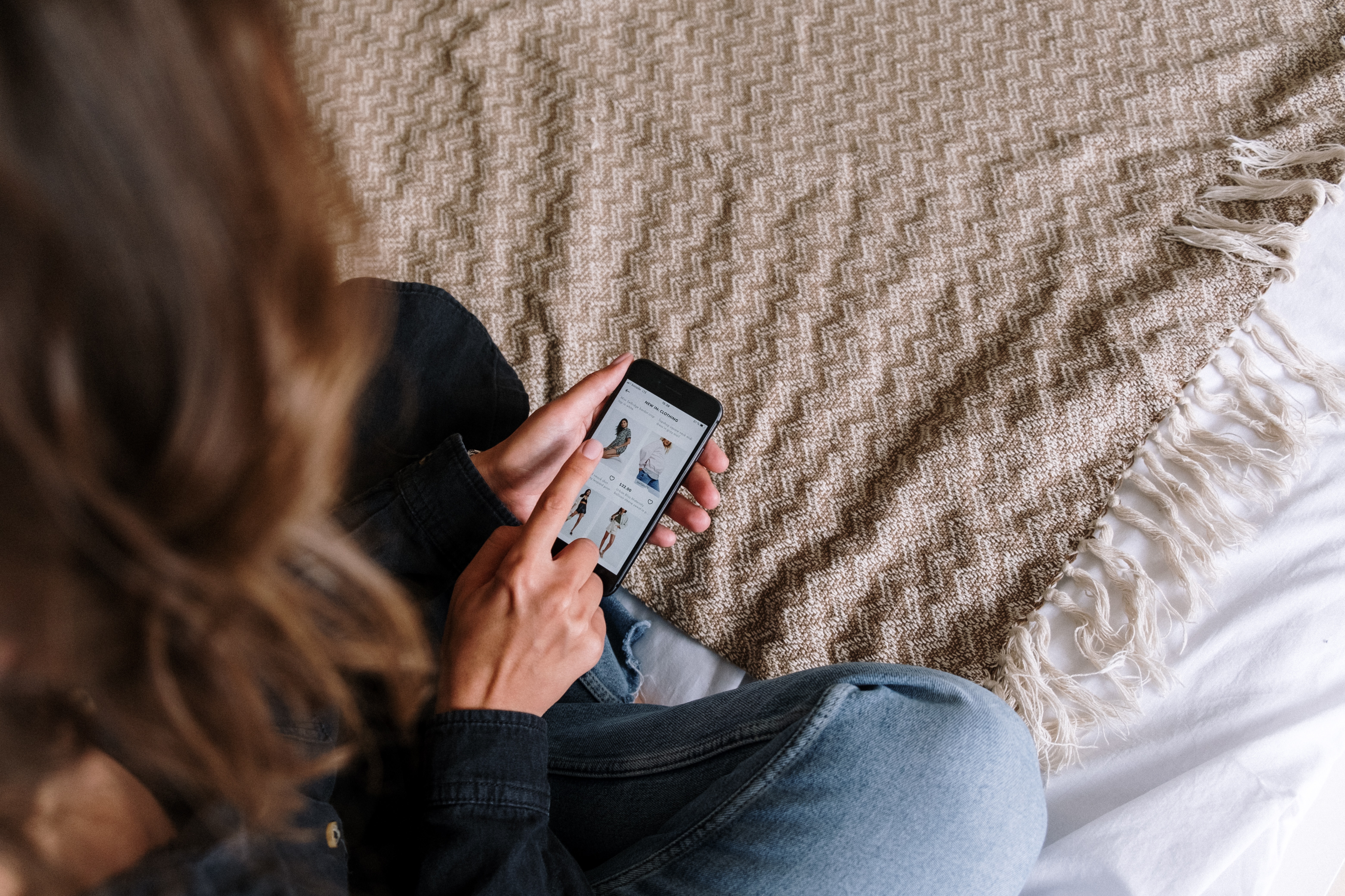 Person online shopping on mobile phone