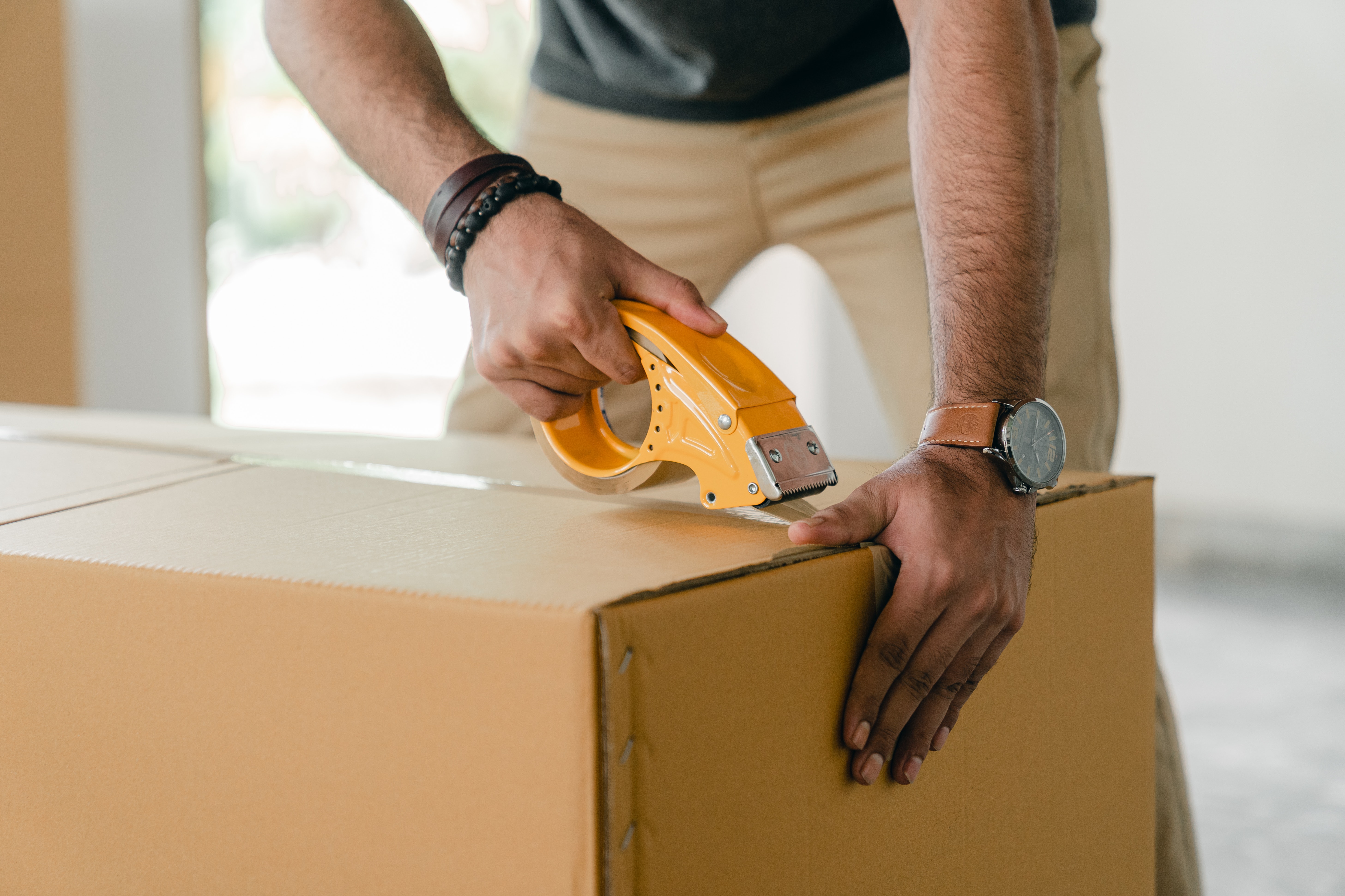 Person taping up a box