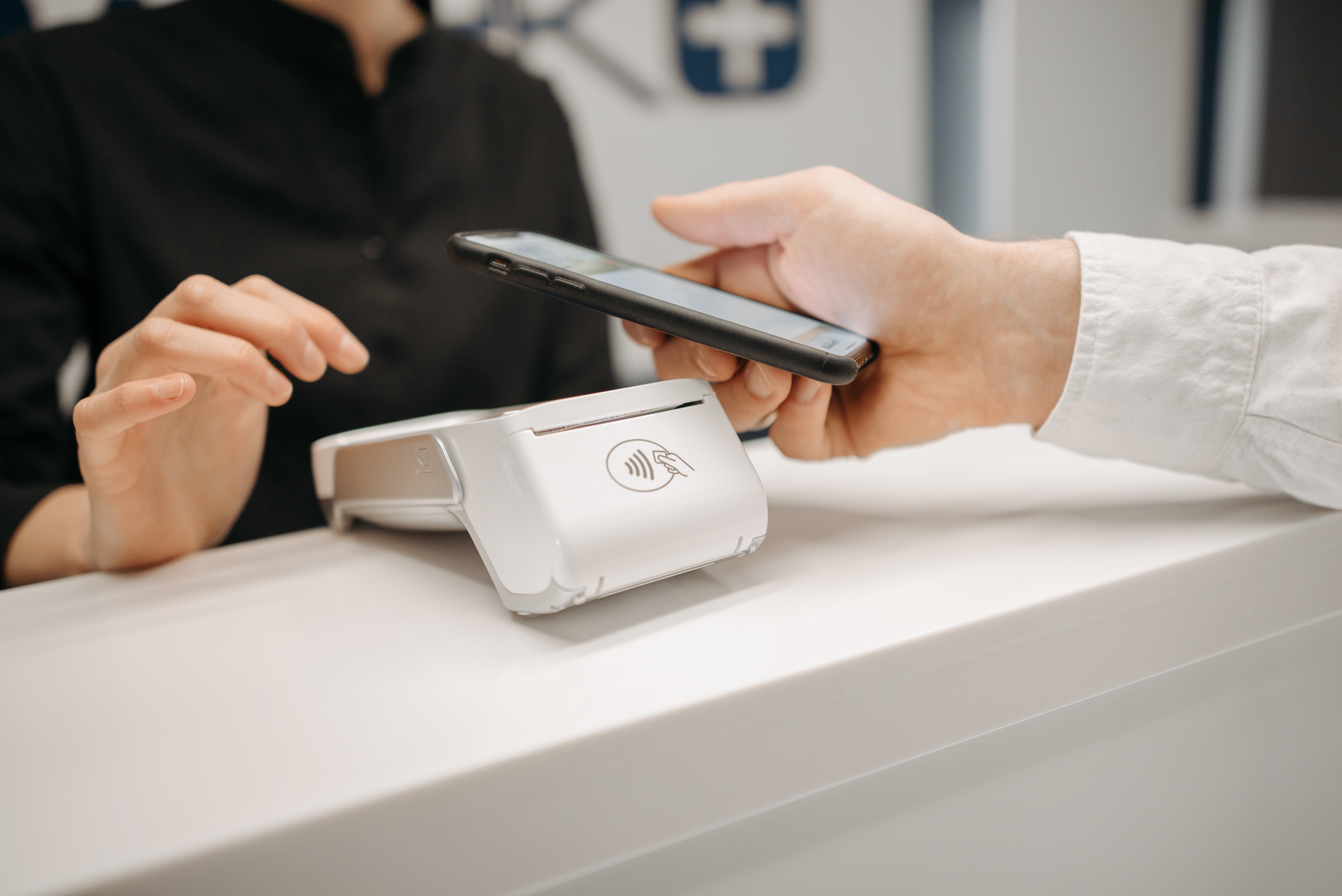 Someone paying using a contactless machine